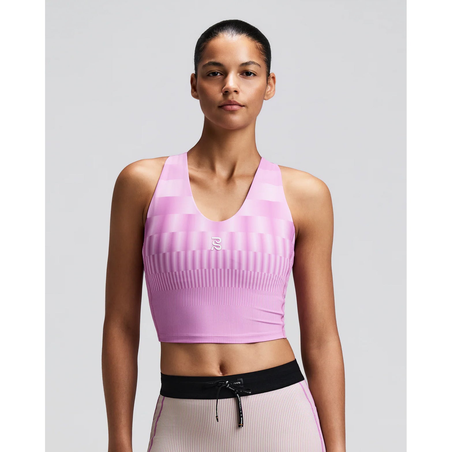 Women's Bandit Vanisher V-Neck Race Crop Top Growing Grid Orchid front view on female runner showing v-neck crop design with Vanisher sweat-hiding compression and waterproof phone pockets