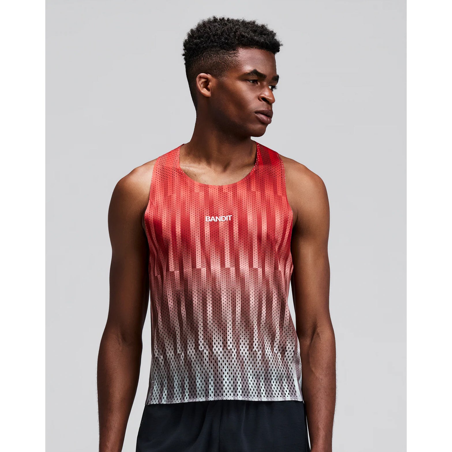 Men's Bandit Shredder Shorty Race Singlet Uneven Gradient Poppy front view on male runner showing cropped fit with two-tone reflective branding and Shredder gradient mesh for race day breathability